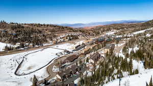 Snowy aerial view with a residential view and a mountain view