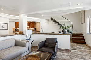 Interior space featuring recessed lighting, wood finished floors, and stairs