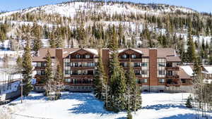 Snow covered property featuring a mountain view