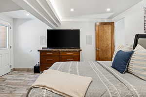 Bedroom with baseboards, light wood-style flooring, and recessed lighting