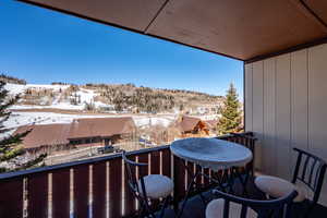 View of snow covered back of property