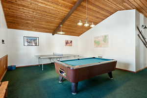 Recreation room with lofted ceiling, wooden ceiling, carpet flooring, and baseboards