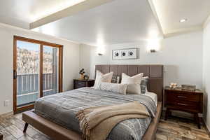 Bedroom with access to exterior, recessed lighting, baseboards, and wood finished floors