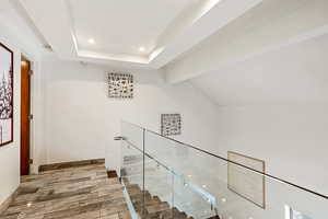 Hall featuring vaulted ceiling with beams, wood finished floors, and recessed lighting