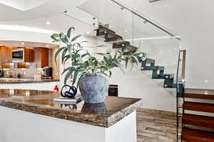 Interior space with a sink, wood finished floors, and recessed lighting