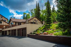 View of front of property featuring a garage and a balcony