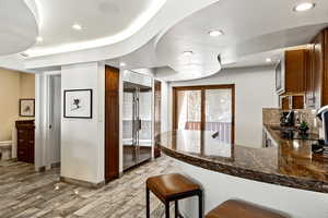 Kitchen with built in refrigerator, light wood-type flooring, a peninsula, and recessed lighting