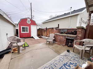 View of patio / terrace featuring a storage unit