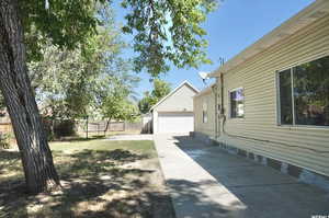 View of yard featuring a garage and an outdoor structure