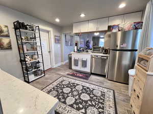 Kitchen with white cabinets, stainless steel appliances, and sink