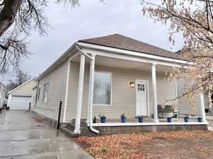 View of front of property featuring a garage and an outdoor structure