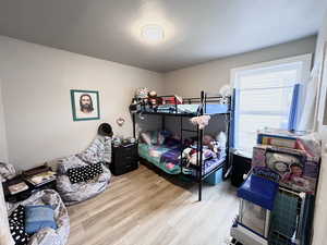 Bedroom with hardwood / wood-style floors