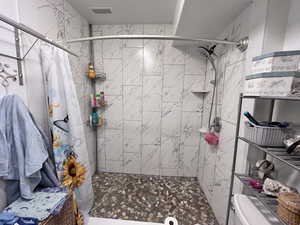 Bathroom featuring a shower with curtain