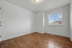 Spare room with hardwood / wood-style floors