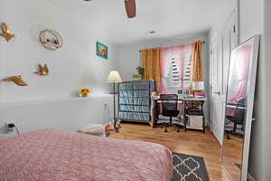 Bedroom featuring ceiling fan and light wood-type flooring