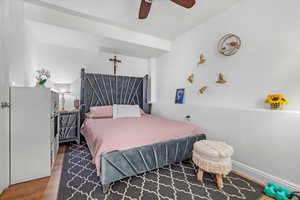 Bedroom with hardwood / wood-style floors and ceiling fan