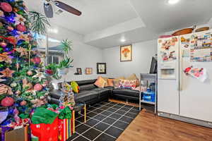 Living room with hardwood / wood-style flooring and ceiling fan