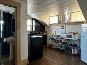 Unit #3 - Kitchen with dark hardwood / wood-style flooring and white appliances