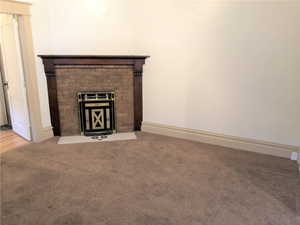 Unit #2 - Room details featuring a fireplace and carpet