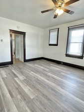 Unit #1 - Unfurnished room with a textured ceiling, light wood-type flooring, and ceiling fan