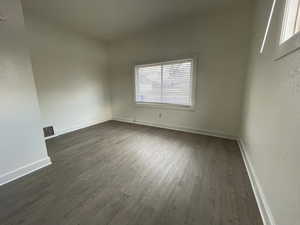 Unit #1 - Bedroom featuring dark wood-type flooring