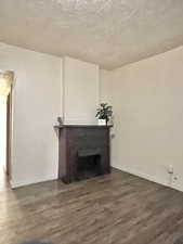 Unit #2 - Living room featuring dark hardwood / wood-style flooring and a fireplace