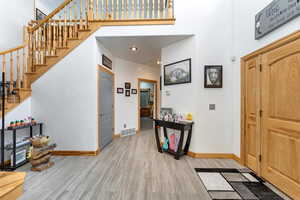Foyer with a high ceiling and light wood-type flooring