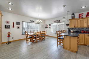 Dining room with light wood-type flooring and a chandelier