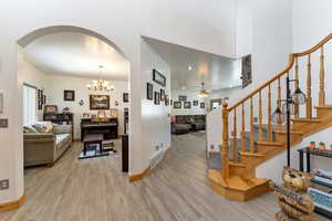 Interior space featuring ceiling fan with notable chandelier and light hardwood / wood-style flooring