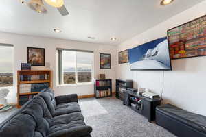 Living room featuring ceiling fan and carpet floors