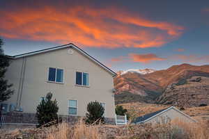 Property exterior at dusk featuring a mountain view