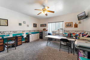 Carpeted home office with ceiling fan