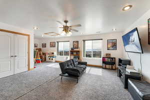 Living room featuring carpet flooring and ceiling fan