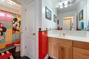 Bathroom featuring vanity, toilet, and walk in shower