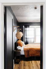 Bedroom featuring a textured ceiling and hardwood / wood-style flooring