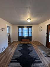 Entrance foyer with hardwood / wood-style floors