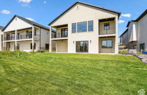Rear view of house with a lawn