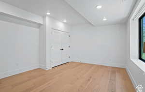Empty room with light hardwood / wood-style floors
