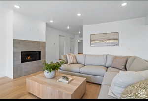 Living room featuring light hardwood / wood-style floors and a tiled fireplace