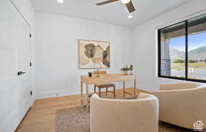 Office with ceiling fan, hardwood / wood-style flooring, and a mountain view