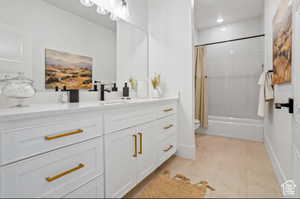 Bathroom featuring vanity and shower / bath combo