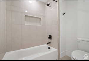 Bathroom featuring toilet and tiled shower / bath