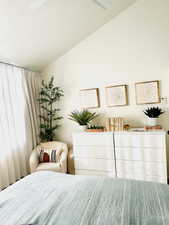 Bedroom featuring a textured ceiling and lofted ceiling