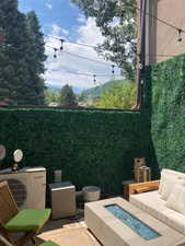 View of patio with ac unit and a fire pit