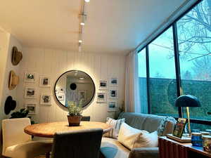 Dining space with wooden walls and track lighting