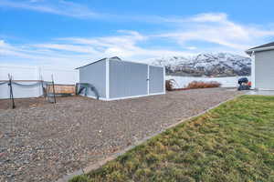 View of outdoor structure featuring a lawn and a mountain view