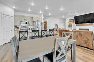 Dining room featuring light wood-type flooring, ceiling fan, and sink