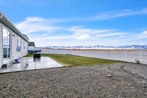 View of yard featuring a mountain view and a patio