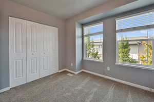 Unfurnished bedroom with carpet flooring and a closet