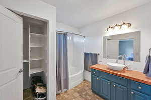 Bathroom with vanity and shower / tub combo